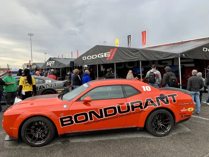 The Dodge and Mopar display at the NHRA Midwest Nationals features Bondurant Driving School Hellcat Challengers