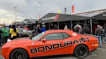 The Dodge and Mopar display at the NHRA Midwest Nationals features Bondurant Driving School Hellcat Challengers